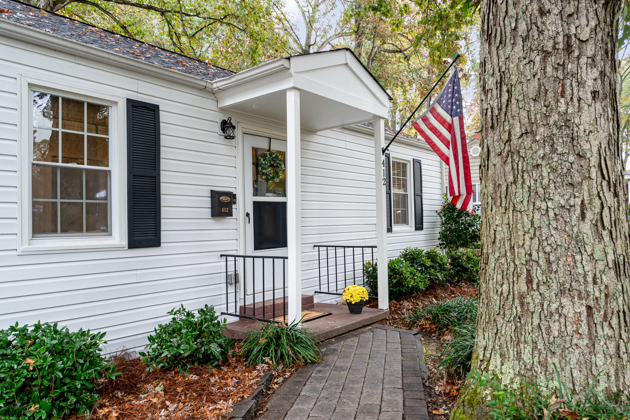 Front View of 412 Nims St, Fort Mill, SC - A charming single-story ranch home with a welcoming front yard, mature trees, and updated exterior in Fort Mill, SC.